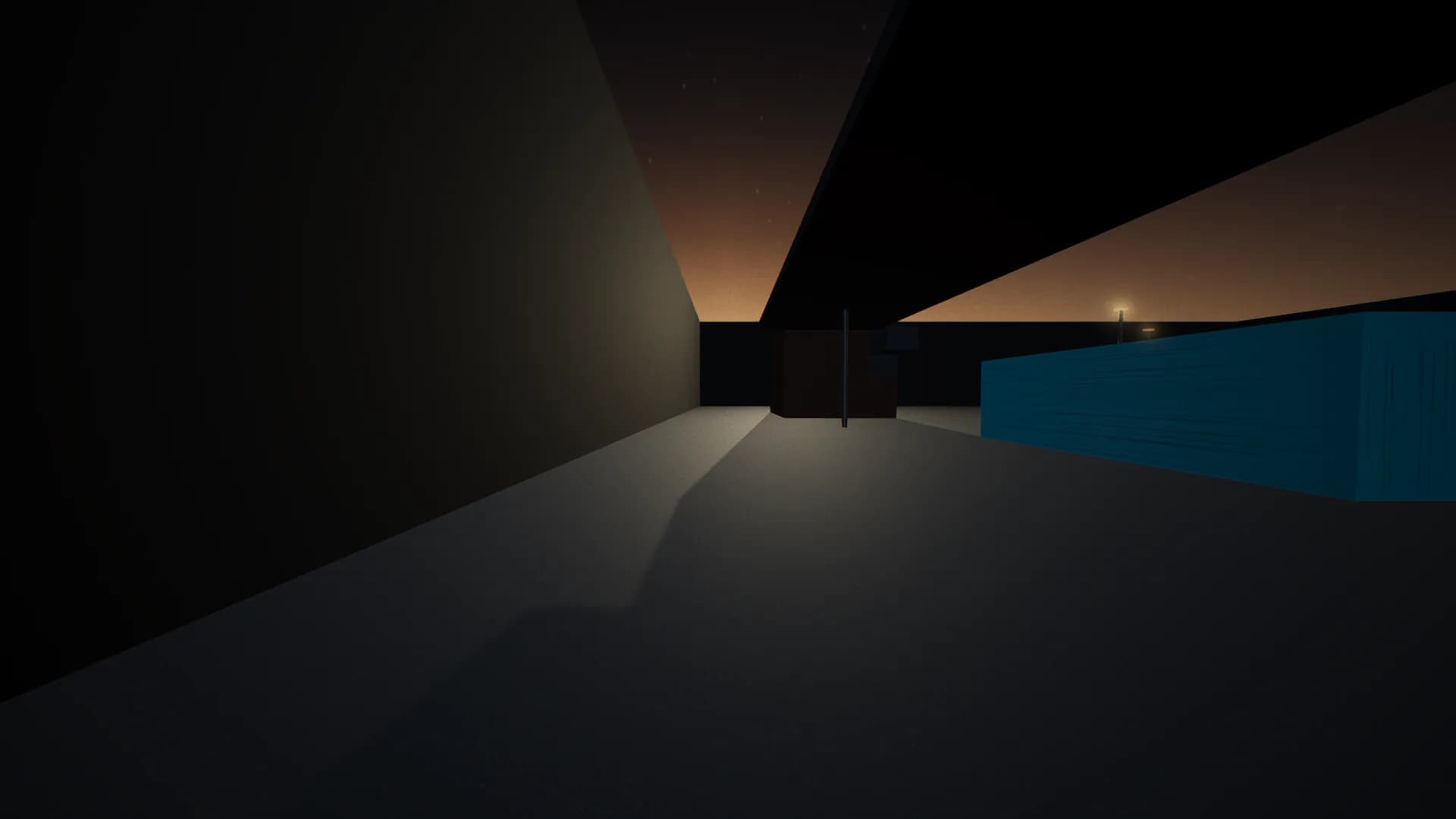 The east lane, running between the storage tanks and the perimeter with the gantry deck overhead.